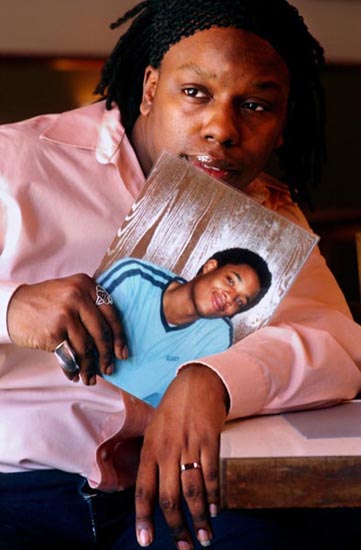 Curtis Johnson holds photo of his friend, Gregory Beauchamp.